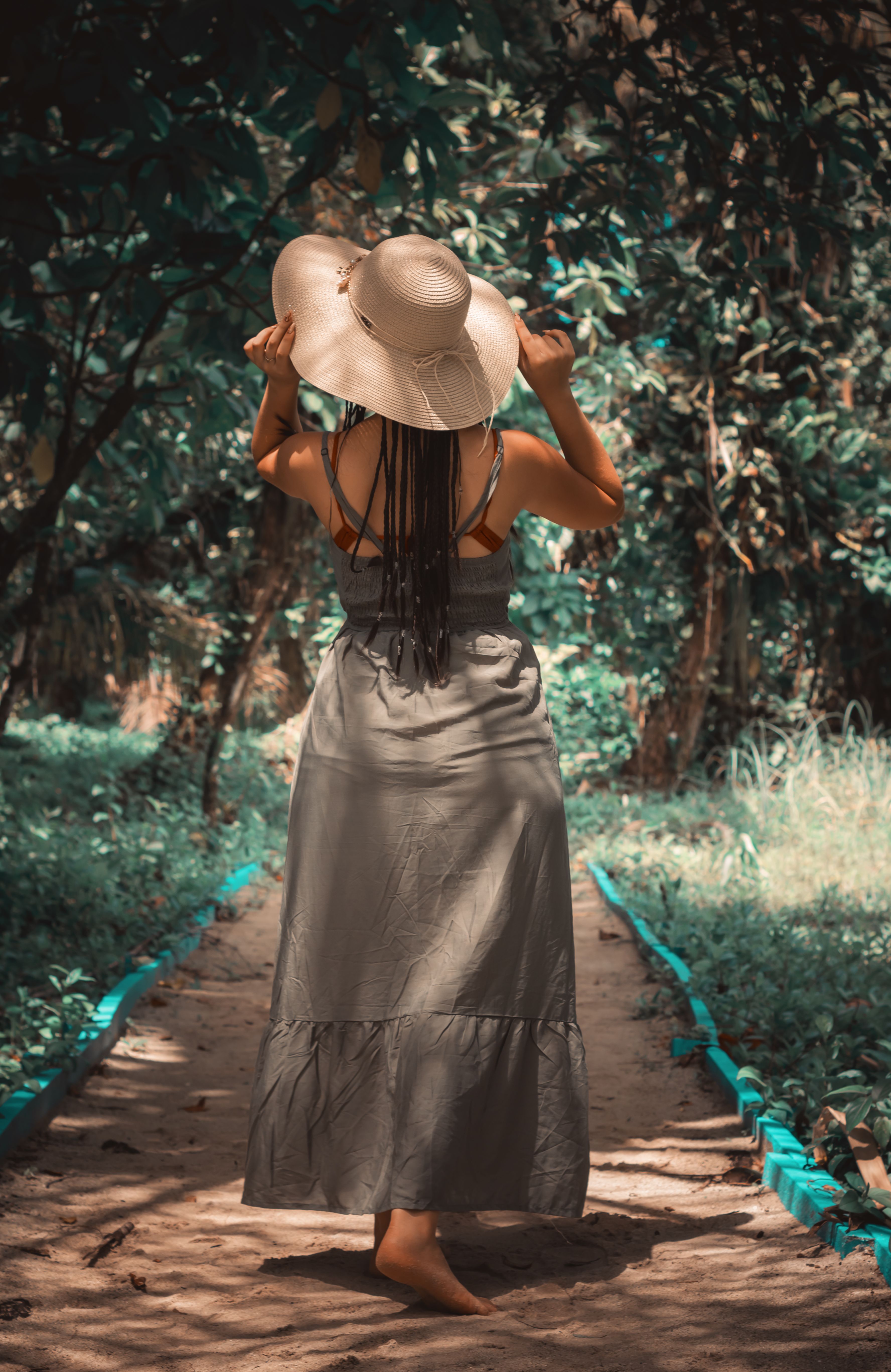 Back View of a Woman Standing on an Unpaved Pathway · Free Stock Photo