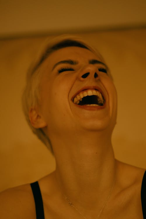 Close Up Photo of Woman Laughing