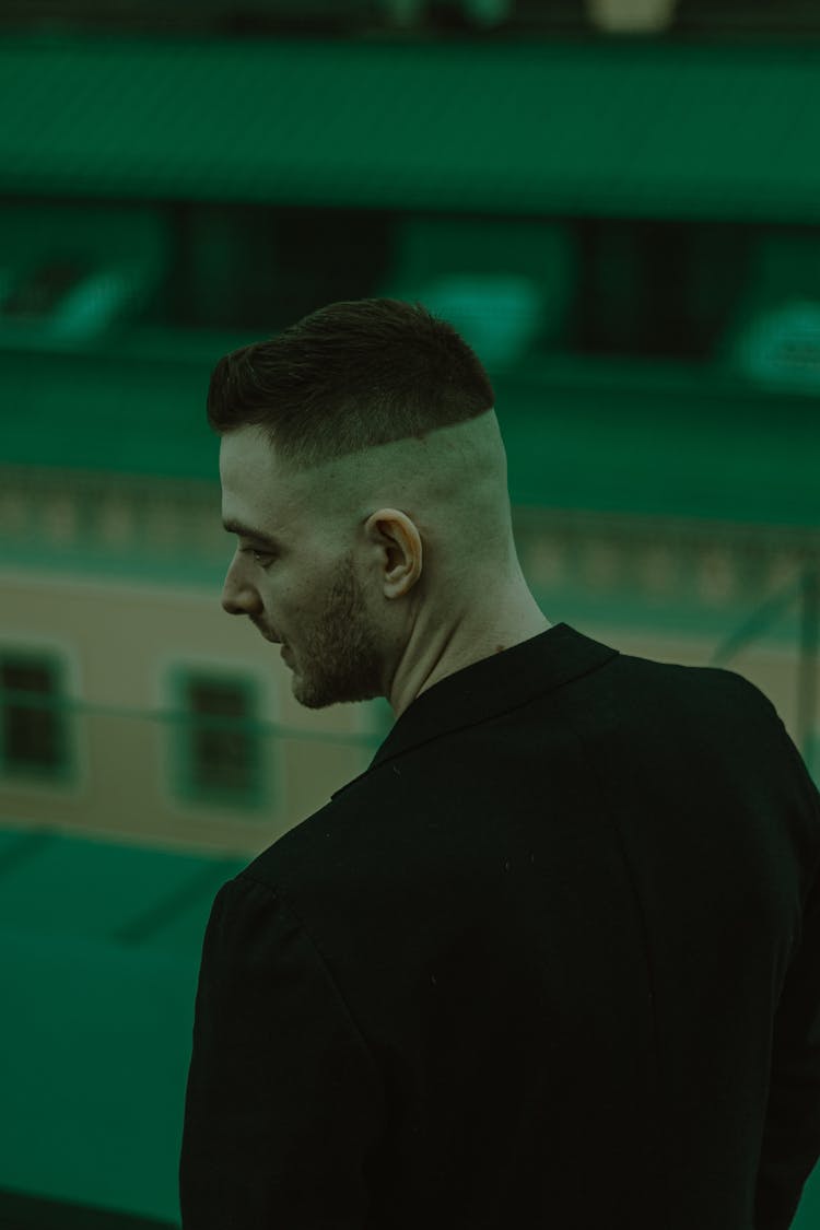 Young Man With Half Shaved Head Standing Backwards