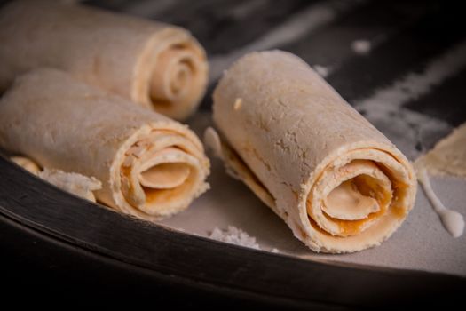 Close-up view of rolled ice cream being prepared with focus on the texture and swirls.