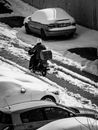 Man in Black Jacket Standing Beside White Car