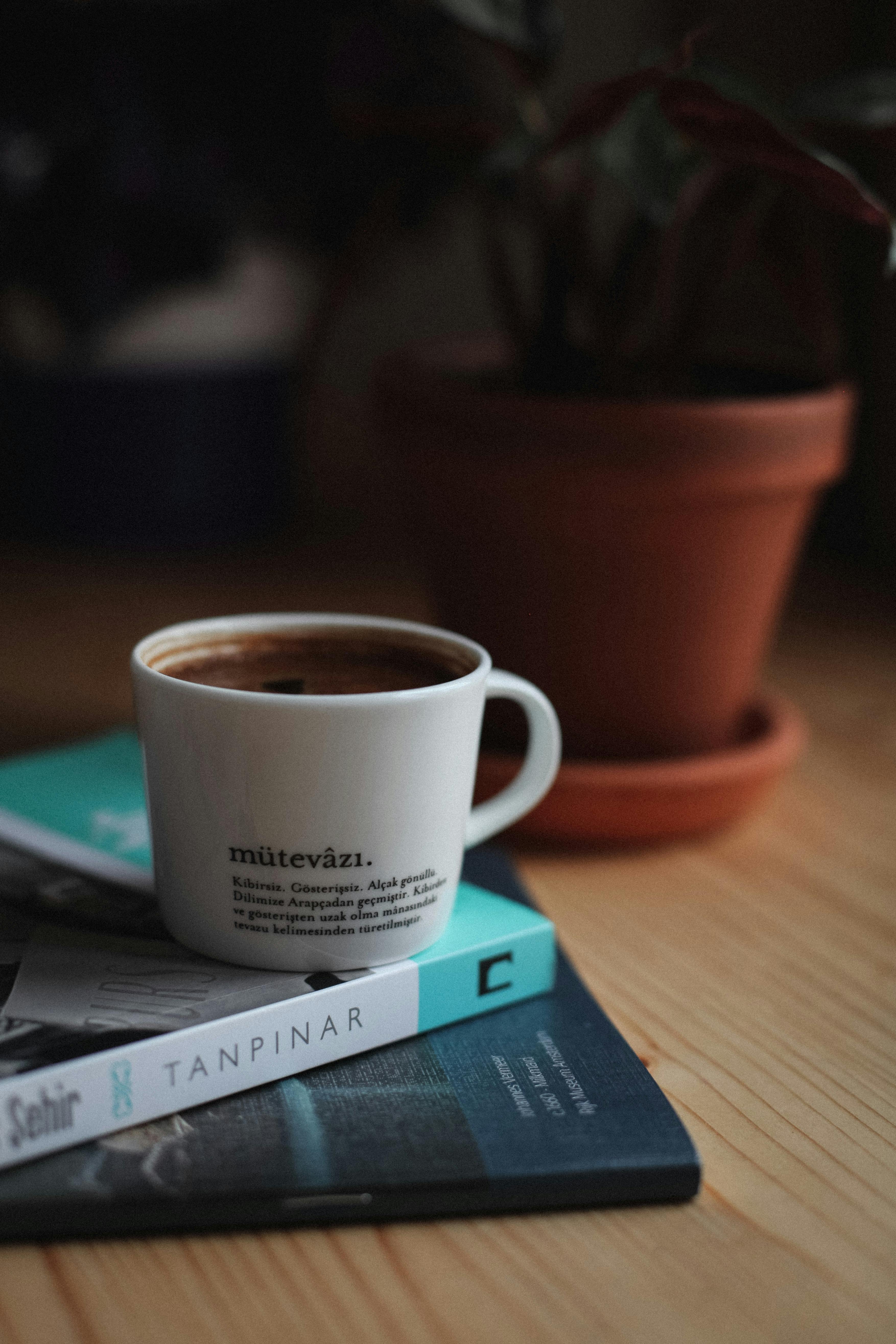 cup of coffee on top of books