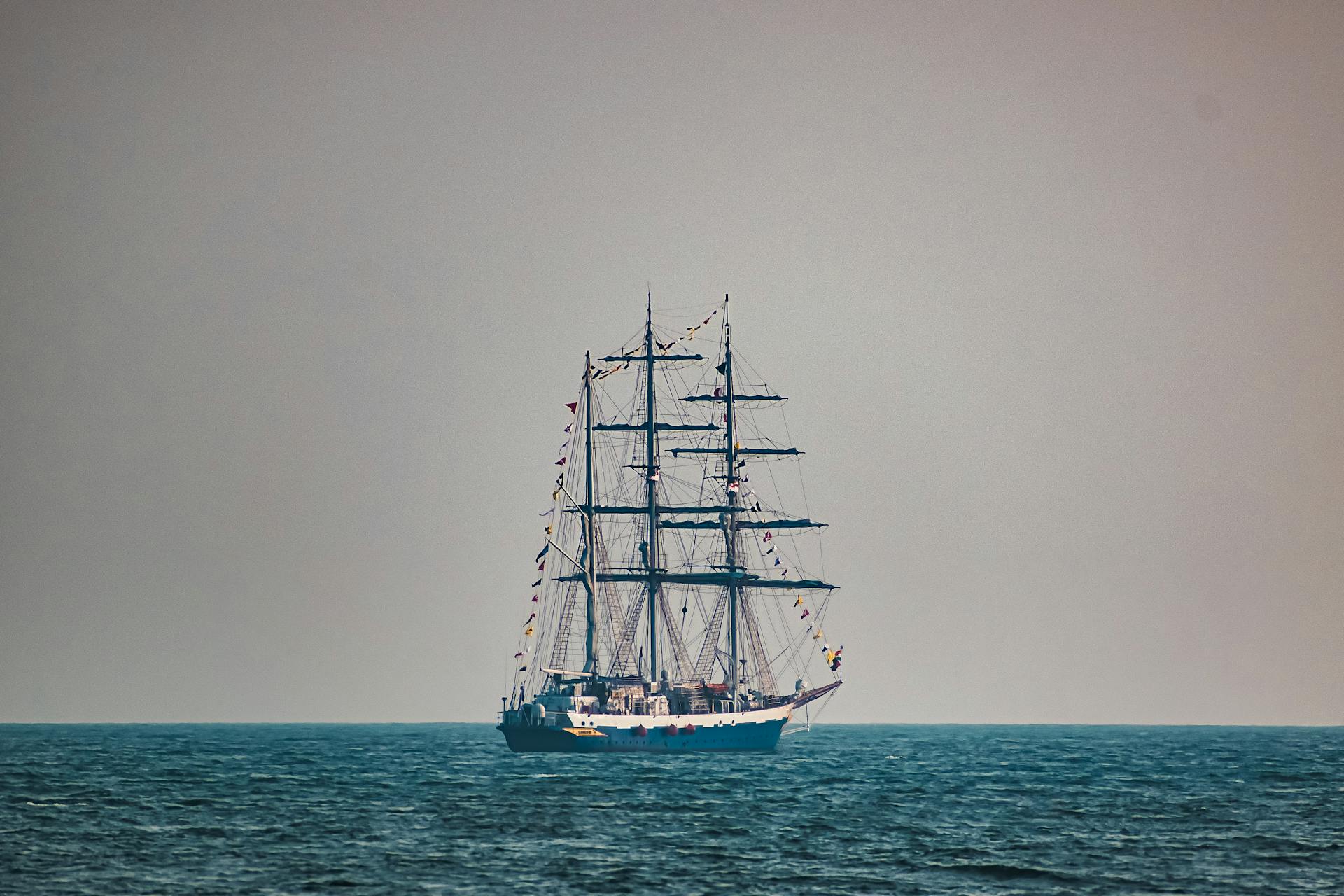 A majestic sailing ship on the serene ocean near Visakhapatnam, India, captured under clear skies.