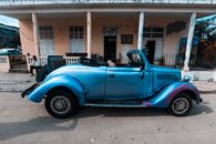 Blue Vintage Car Parked in Front of a House