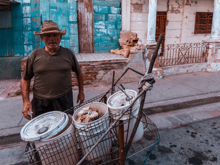 A Man In A City With A Shopping Cart