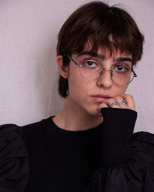 Close-Up Shot of a Pretty Woman in Black Long Sleeves Wearing Eyeglasses