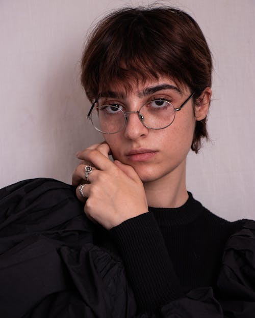 Close-Up Shot of a Pretty Woman in Black Long Sleeves Wearing Eyeglasses