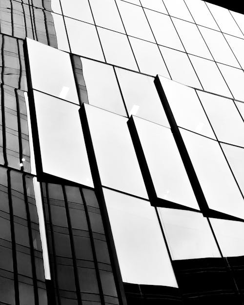 Grayscale Photo of a Glass Building