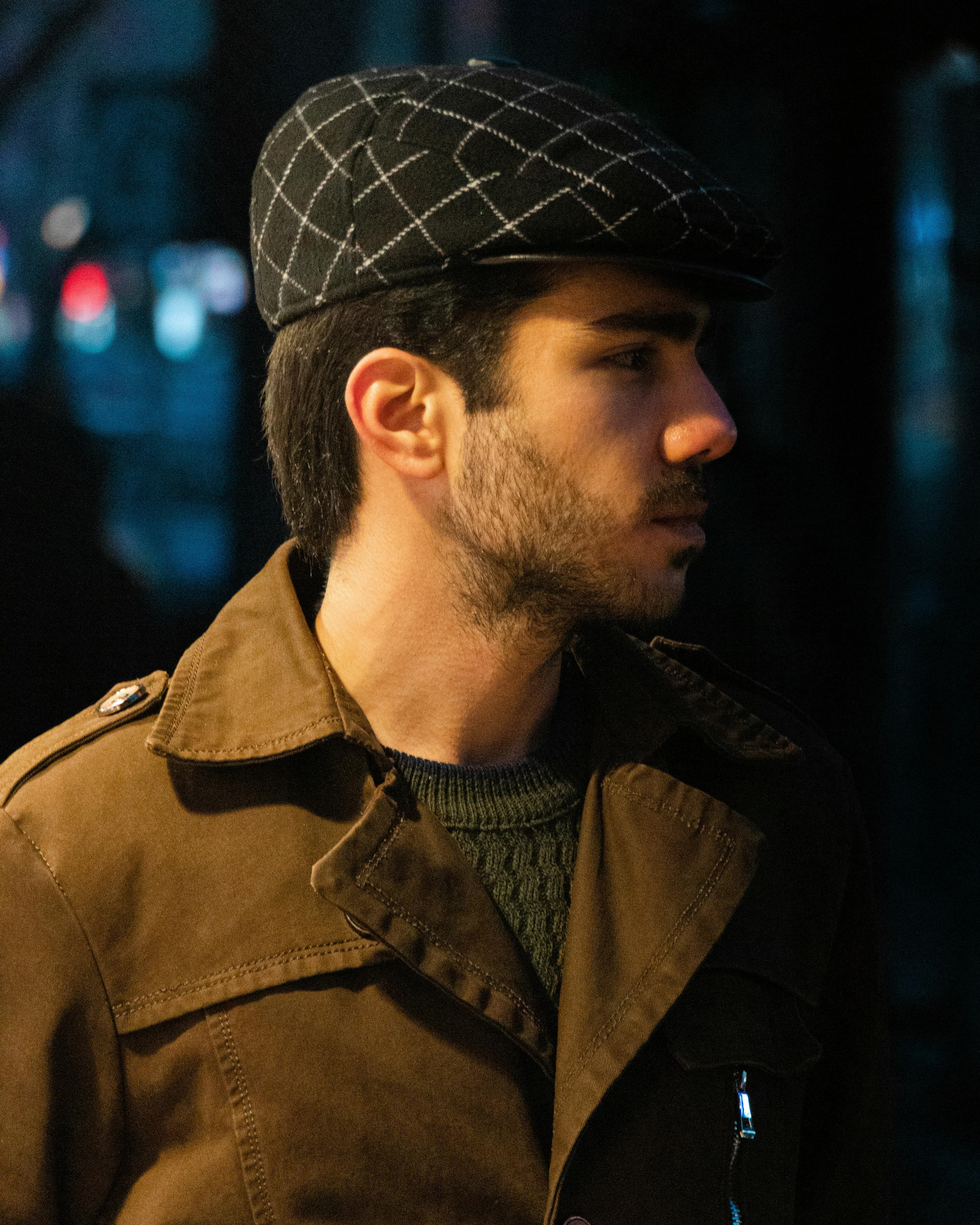 Side View of a Young Man in a Newsboy Cap · Free Stock Photo