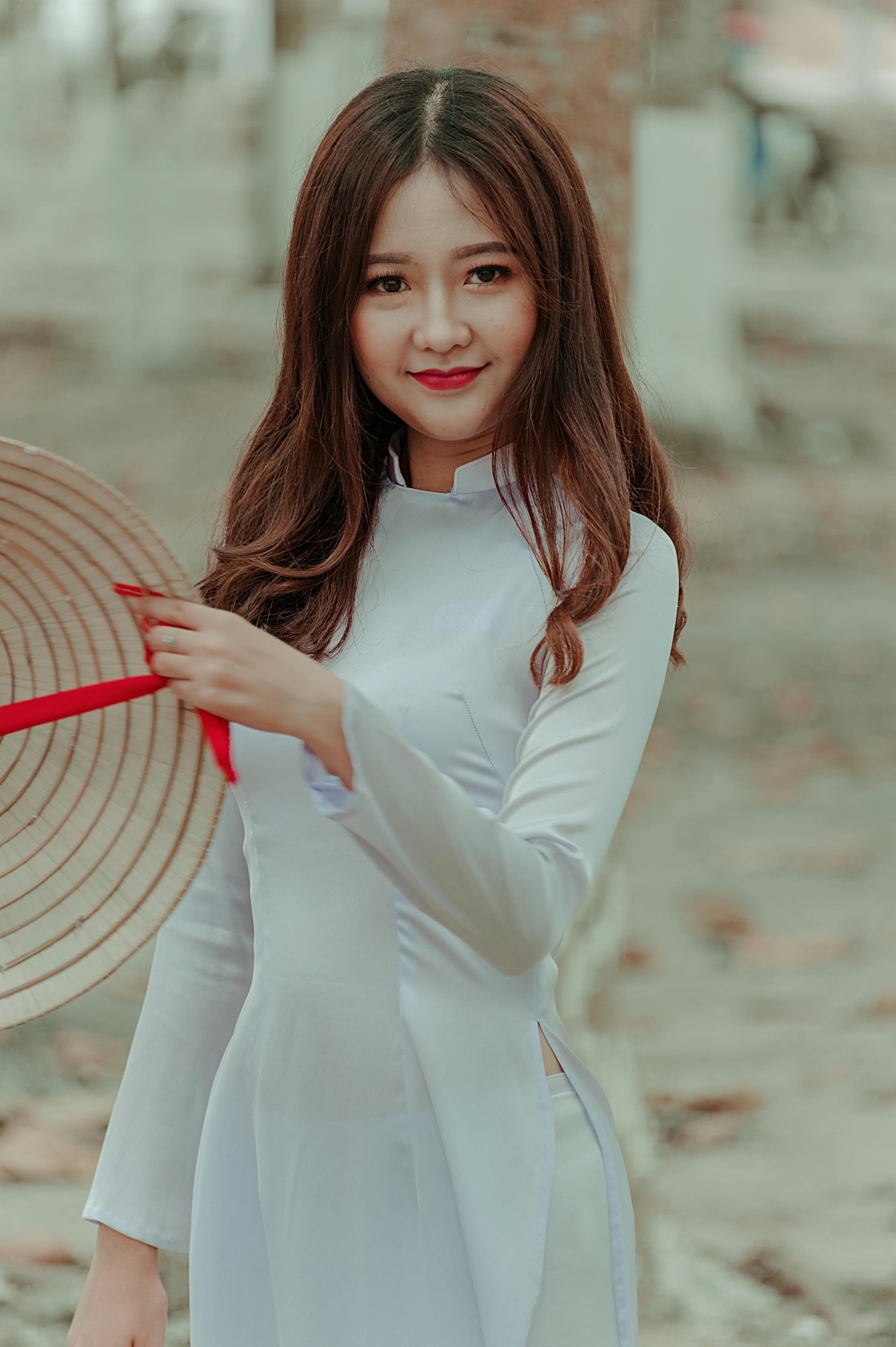 Woman Wearing White Long-sleeved Dress Holding Straw Hat · Free Stock Photo