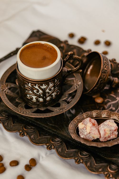 Free Close-up of Turkish coffee in ornate cup with delights on an intricate tray, showcasing traditional elegance. Stock Photo