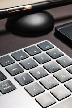 A detailed close-up of a sleek computer keyboard with numerical keypad.