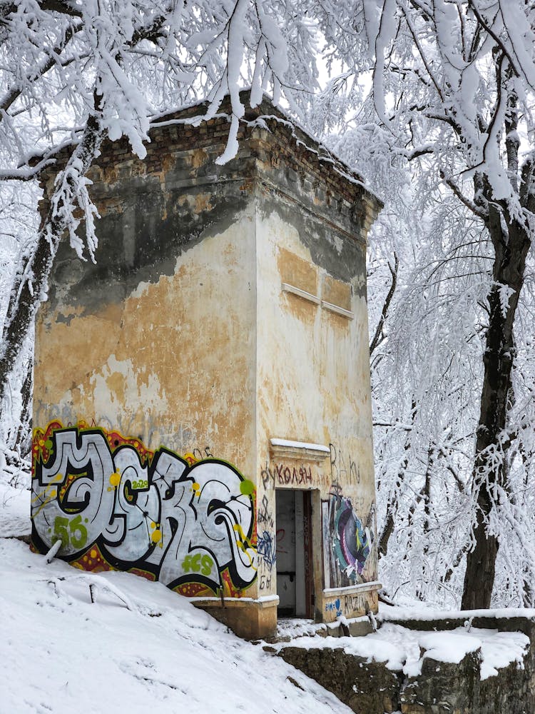 Abandoned Building With Graffiti In Snow 