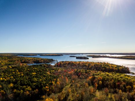 A stunning aerial view of Jakes Landing, Nova Scotia in autumn, showcasing vibrant foliage and serene lakes.