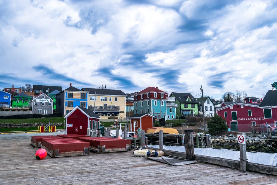 Colorful historic buildings by the harbor under a dramatic sky