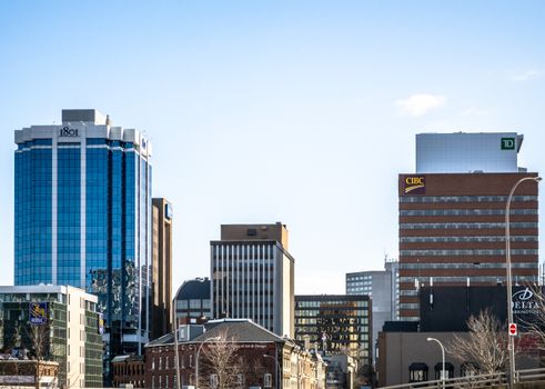 Skyline view of modern corporate office buildings against a clear blue sky.