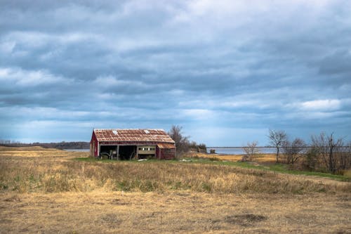 Rusty Roof Barn on Grass Field
