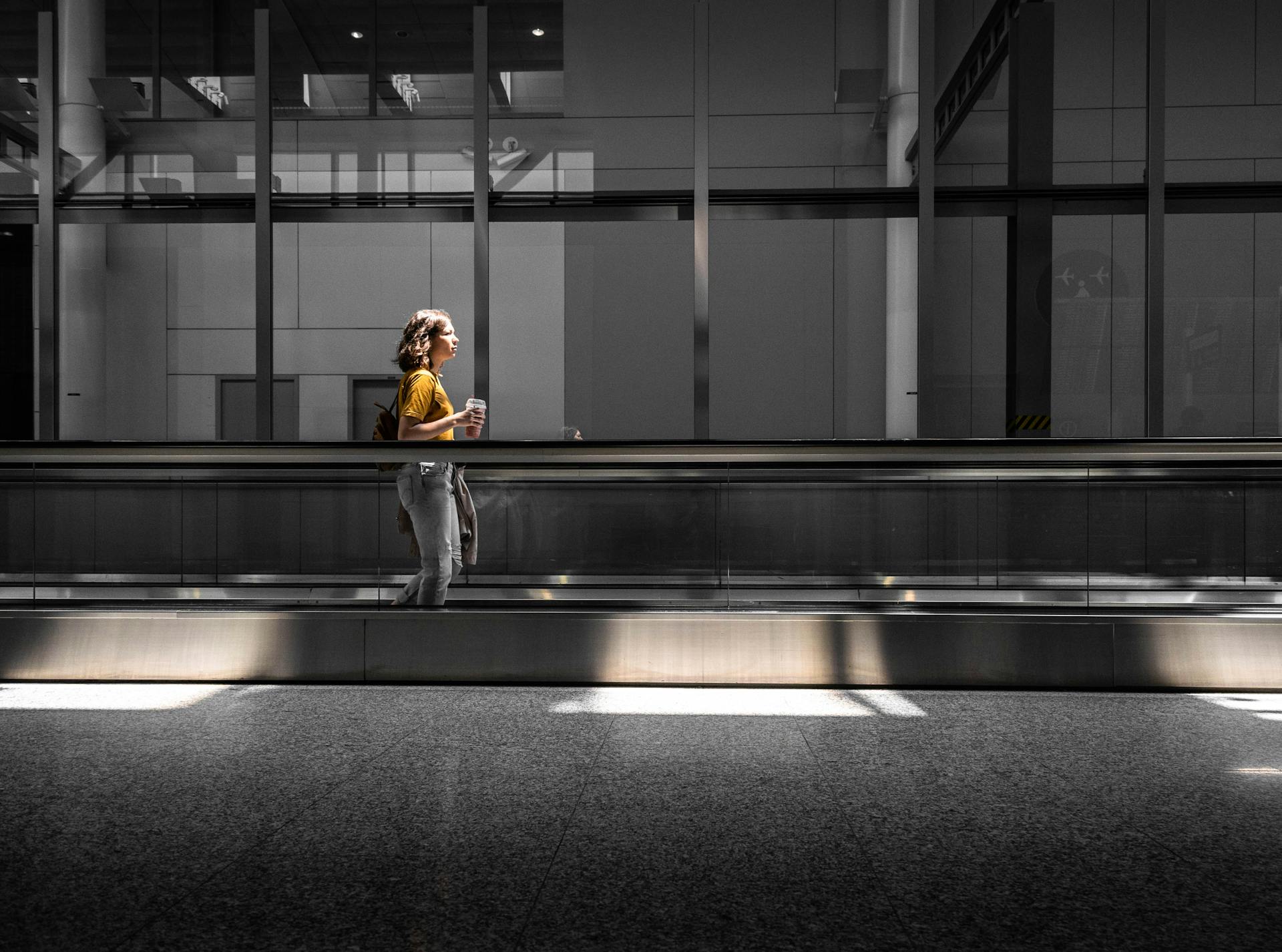 Woman in Yellow Shirt Holding Plastic Cup