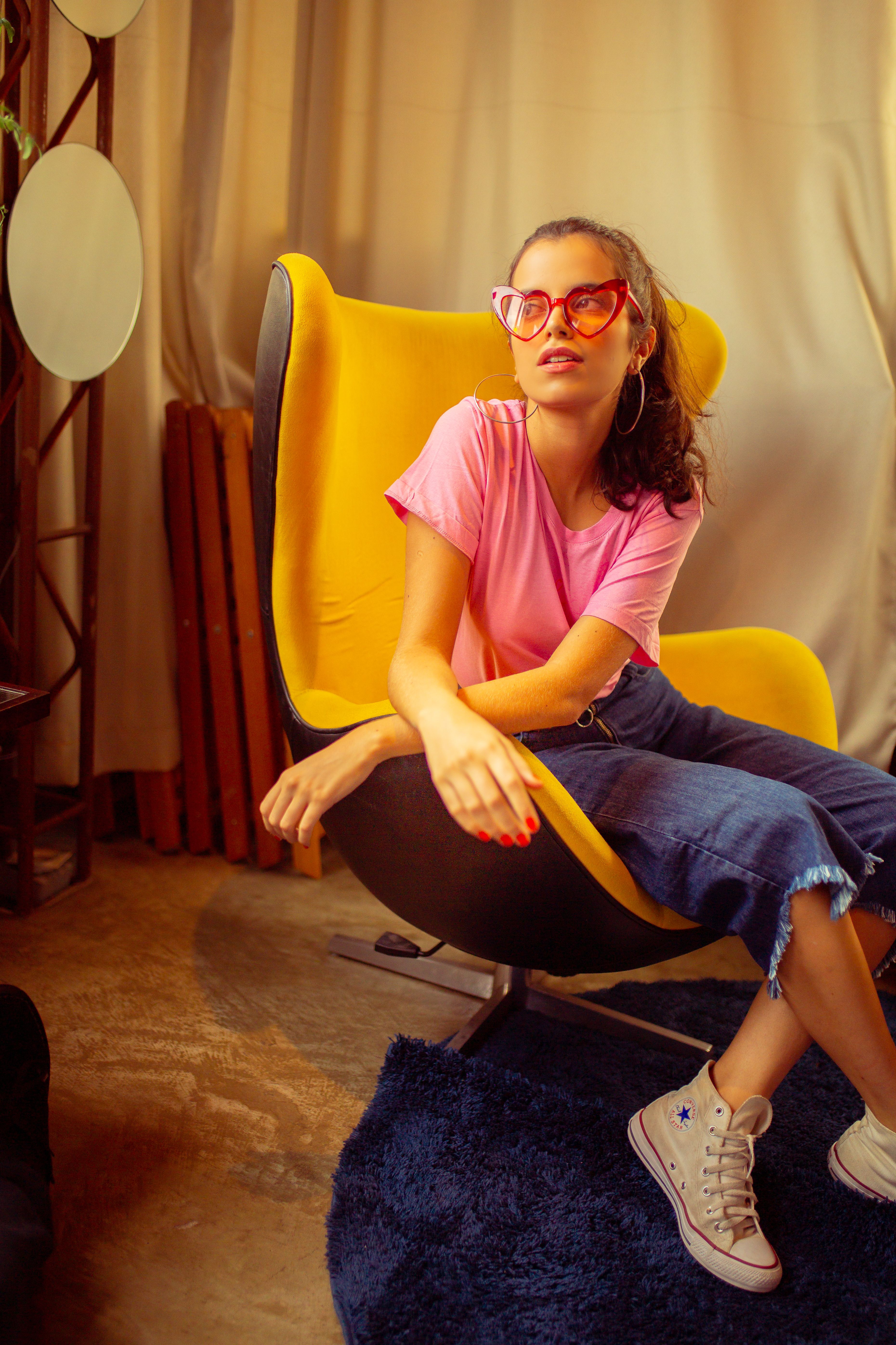 A Woman in Pink Top Sitting on a Chair · Free Stock Photo