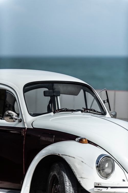 Free Classic Volkswagen Beetle near Brazilian seaside with clear sky background. Stock Photo