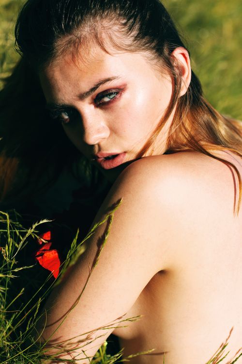 Free A captivating portrait of a woman in nature with soft natural lighting and artistic expression. Stock Photo