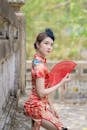 Girl in Red and White Floral Dress Holding Red Umbrella