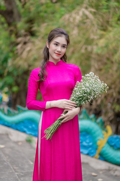 A Woman in Pink Long Sleeve Dress