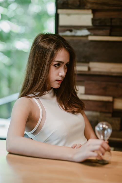 A Woman in White Sleeveless Shirt