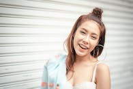 A Woman Wearing Hoop Earrings Smiling Beautifully at the Camera
