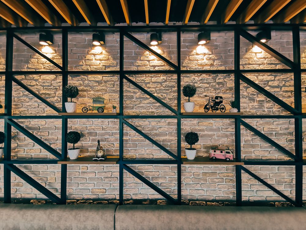 Decorative wall shelving styled with objects and warm interior lighting