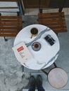 White Ceramic Mug on White Round Table