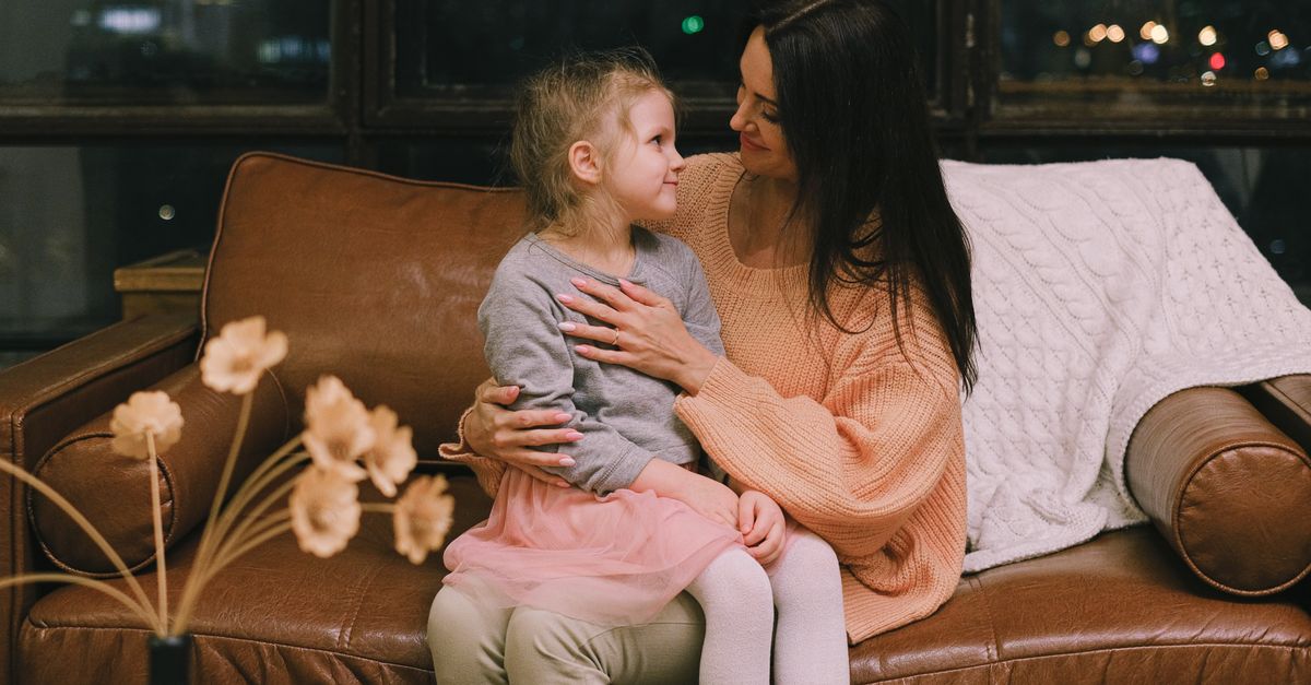 A mother holding her child in a warm, intimate embrace, soft natural lighting, living room setting in Texas suburban home