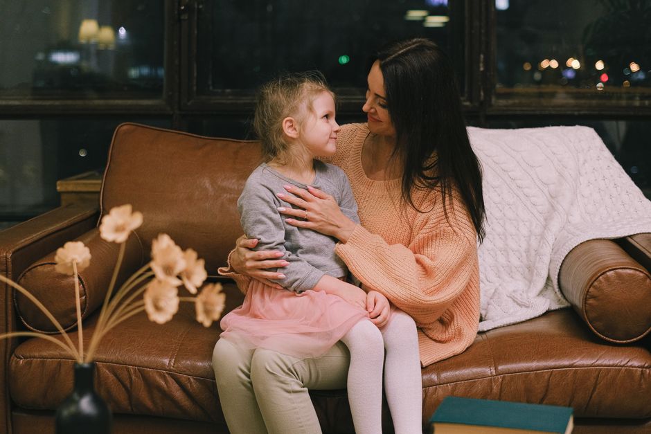 Photo by Anna Shvets on Pexels A mother and daughter sharing an affectionate moment on a leather sofa indoors. - Photo by Anna Shvets on Pexels