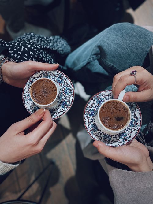 Free Close-up of two people holding traditional Turkish coffee cups in Istanbul, Turkey. Stock Photo