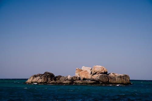 Brown Rock Formation on Blue Sea 