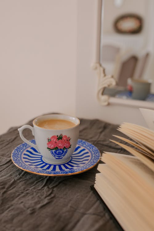 White and Blue Floral Ceramic Teacup on White and Blue Floral Ceramic Saucer