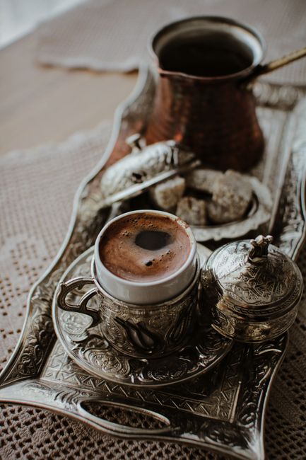 An exquisite setup of traditional Turkish coffee served with sweet treats on an ornate tray.