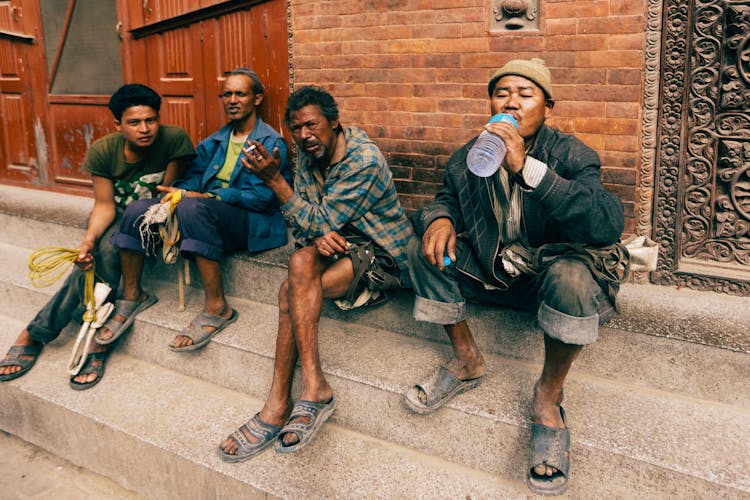 Men Sitting On Steps Of Temple