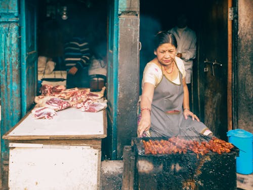 Woman grilling food 