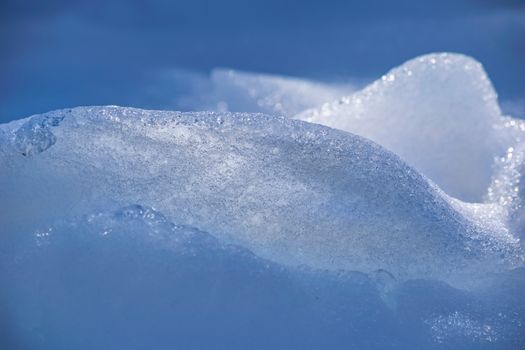 Detailed close-up of glacial ice and snow textures, capturing the crisp, cold essence of winter.
