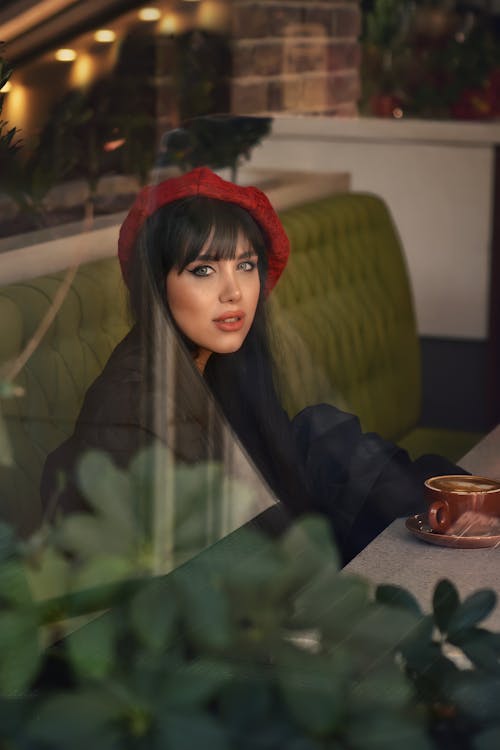 Young Woman Sitting in a Cafe 