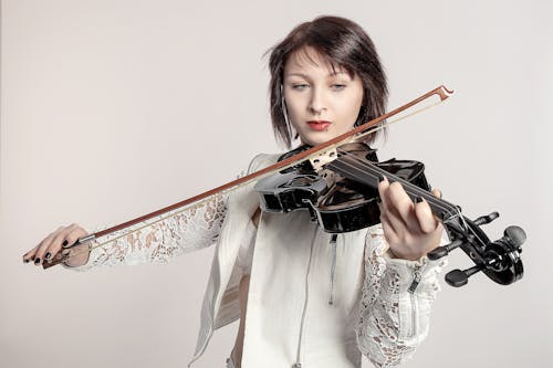 Woman in White Clothes Playing Violin 