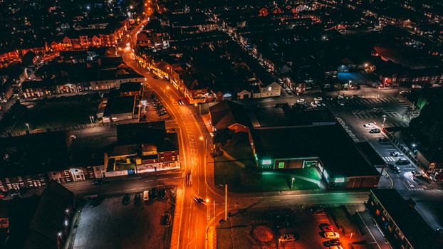 Captivating aerial view of a city at night with glowing streetlights and buildings.
