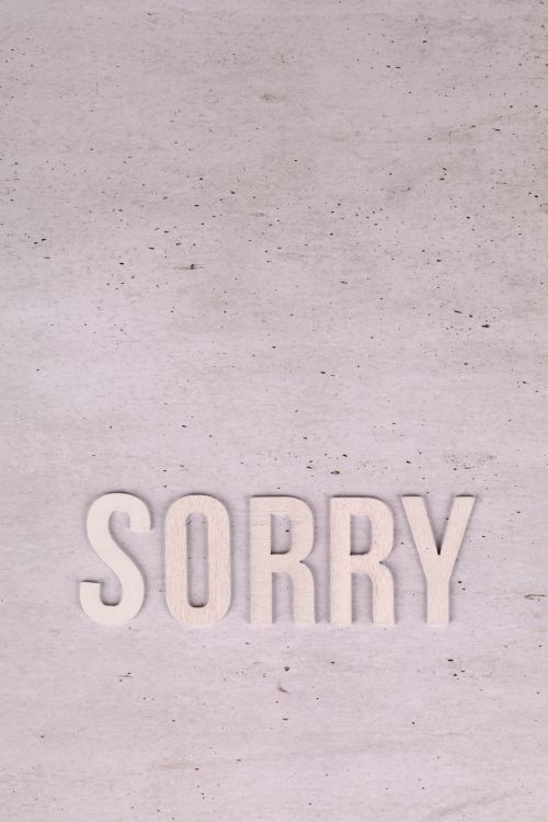 Free Top view of the word 'SORRY' on a concrete texture, perfect for apology themes. Stock Photo