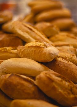 A close-up of assorted freshly baked bread loaves, showcasing their texture and color.