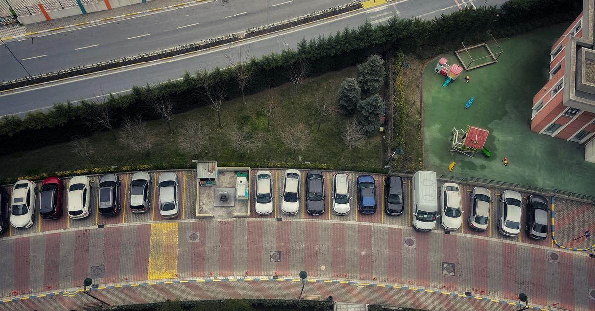 Drone shot of cars parked along a curved road in Istanbul, Turkey.