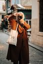 A Photographer in a Brown Coat