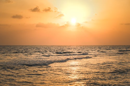 Ocean Waves on Body of Water during Sunset