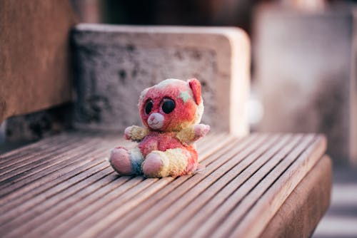 Free Brown Bear Plush Toy on Brown Wooden Table Stock Photo