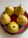 Yellow and Red Apples on Red and White Round Plate